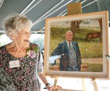 Ellie Kouwenhoven helps unveil new portrait of her husband Gerrit.